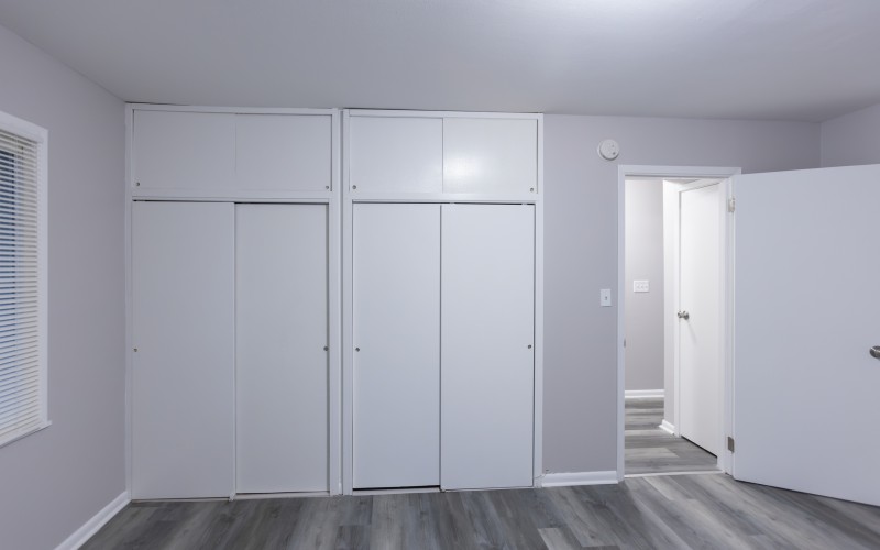 Similar one-bedroom apartment: bedroom with wall-to-wall closets at Carriage House Apartments, Syracuse NY