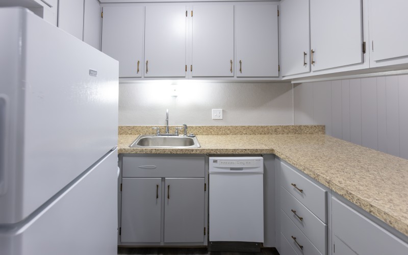 Similar one-bedroom apartment: kitchen with granite-look counters and dishwasher at Carriage House Apartments, Syracuse NY