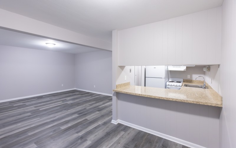 One-bedroom living area with granite breakfast counter at Carriage House Apartments, Syracuse NY
