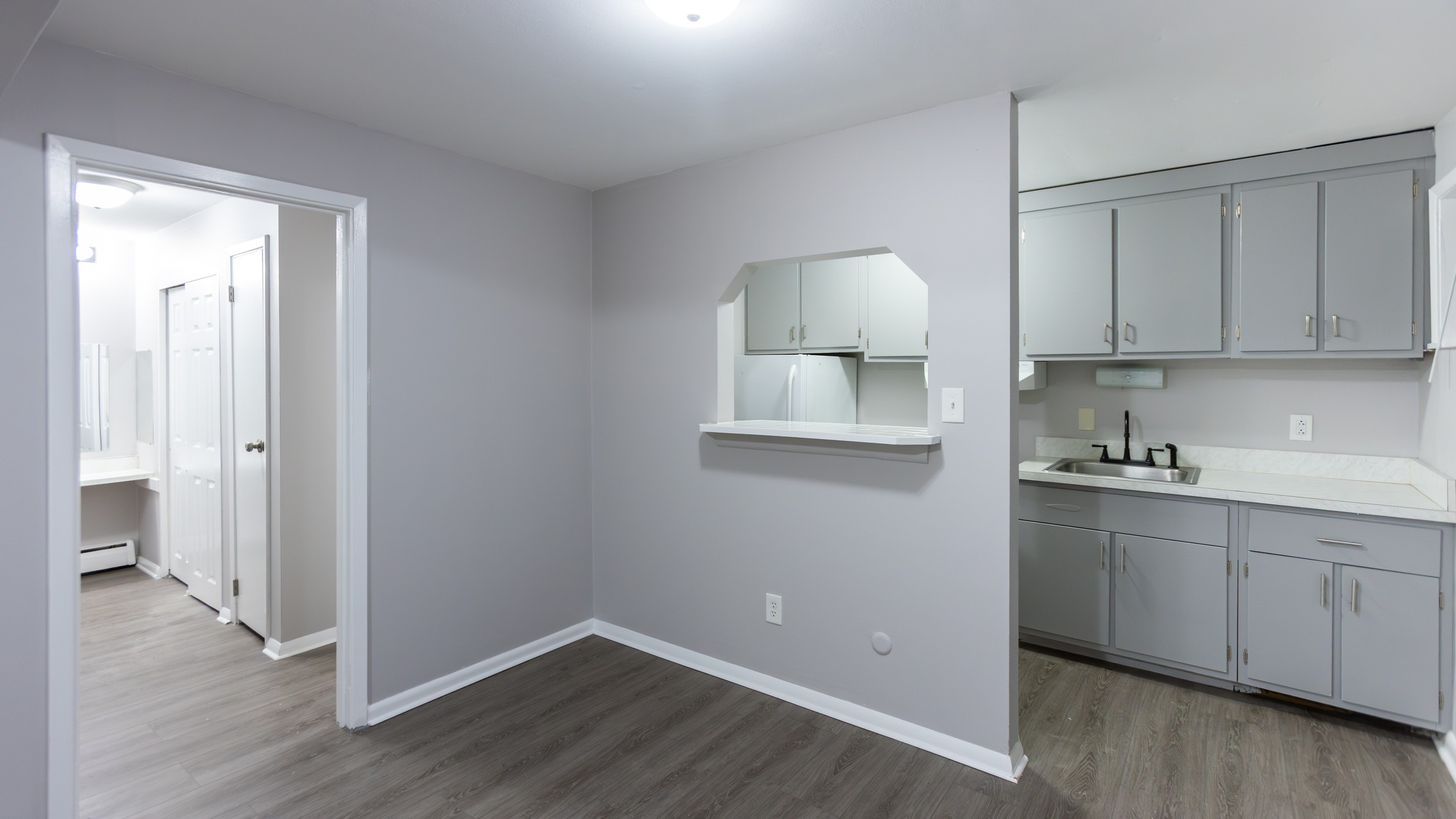Studio main room with kitchen pass-through at Carriage House Apartments, Syracuse NY