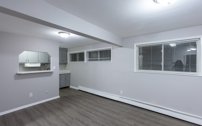 Similar studio apartment: main room with kitchen pass-through and windows at Carriage House Apartments, Syracuse NY