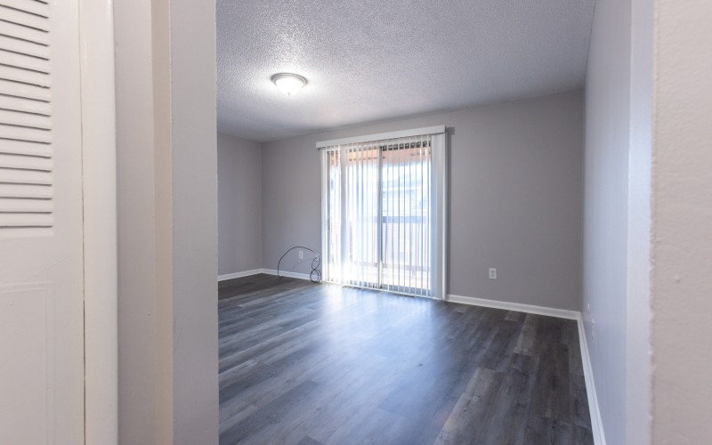 Similar apartment: living room with a sliding glass door at Carriage House Apartments, Syracuse NY