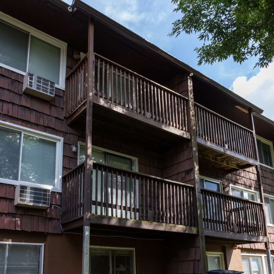 Wooden balconies on a three-story building at Carriage House Apartments, Syracuse NY