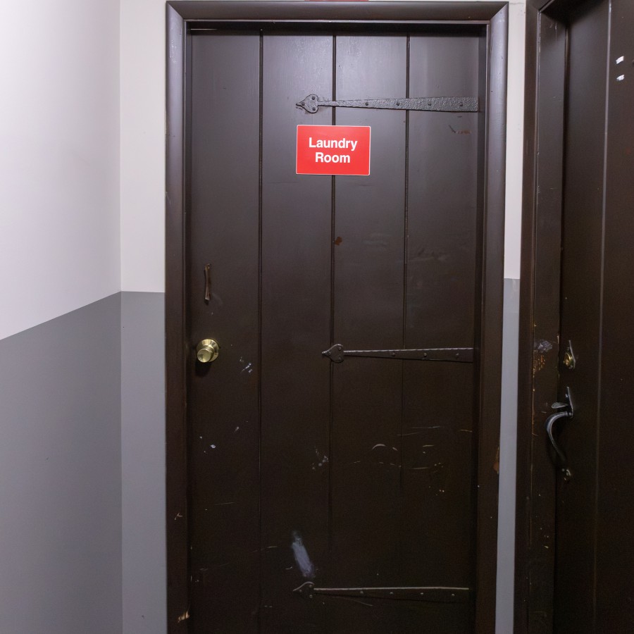 Laundry room door in a building hallway at Carriage House Apartments, Syracuse NY